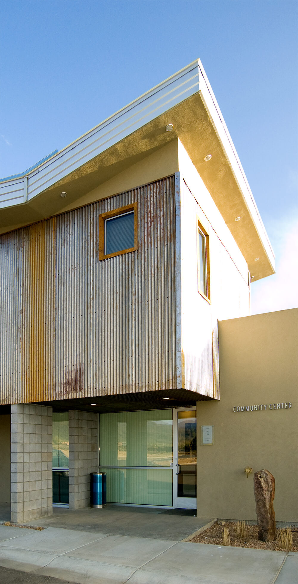The community center entrance with its weathered corrugated-steel upper story
